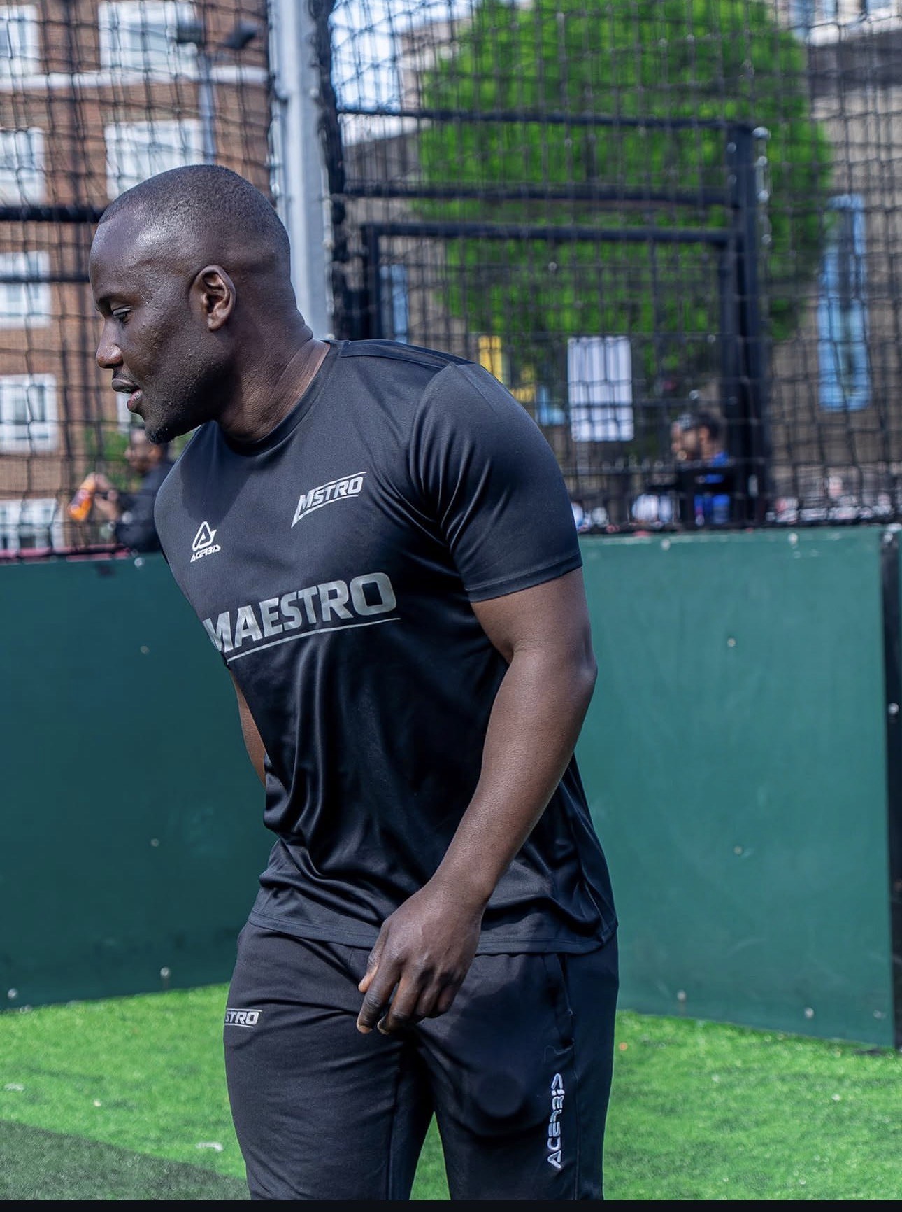 Maestro head coach in kit on the pitch